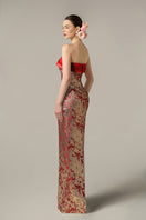 Red metallic jacquard and silk taffeta gown by I.H.F with intricate patterns and elegant draping.