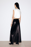 Black faux leather midi skirt by ELENAREVA, shown on a model with a high waist and sleek, fitted design.