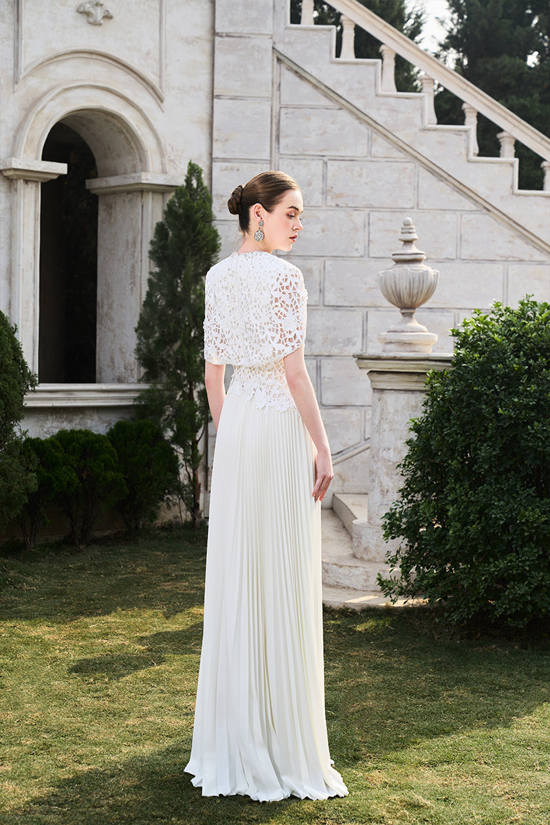 Tracy Studio grain weave gown featuring textured fabric, long sleeves, and a flowing silhouette perfect for elegant occasions.