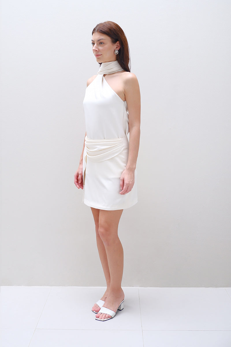 Cream AMIRA mini skirt by Aidan & Ice, featuring a fitted waist and stylish short length, displayed on a model.