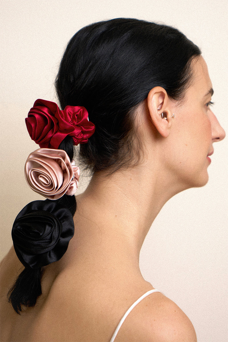 Four Tuscan Rose silk scrunchies, soft and luxurious hair accessories from Not Just Pajama, displayed in a close-up shot.