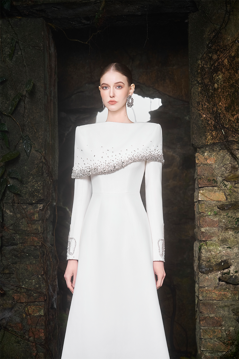 Elegant Tracy Studio Diagonal Crystal-Embellished Shoulder A-Line gown with intricate crystal details and flowing fabric.