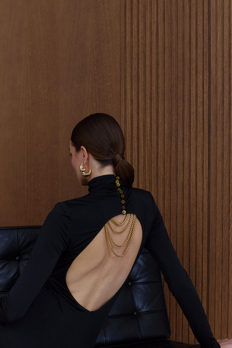 Black Cintia open-back maxi dress by UNDRESS, featuring a flowing silhouette and elegant open-back design.