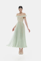 Montsand mint off-shoulder midi dress displayed on a hanger, featuring flowing fabric and stylish off-shoulder design.