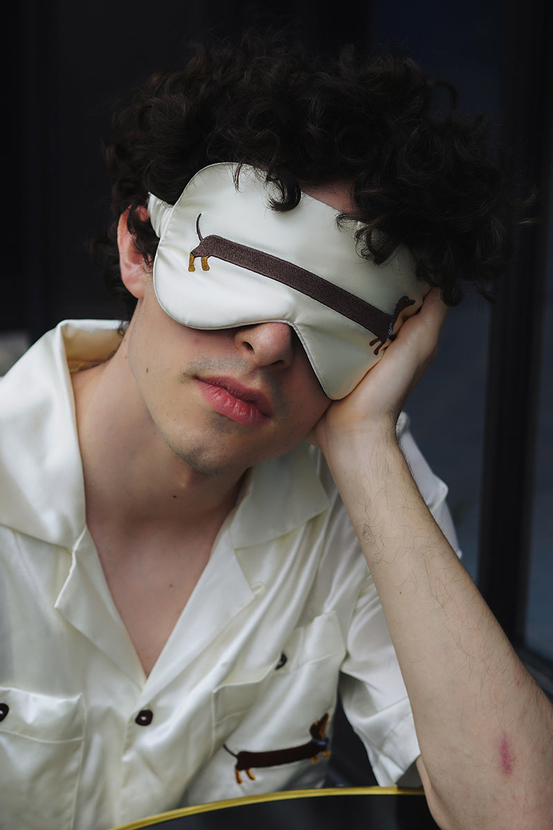 White DACHSHUND DREAM silk sleeping eye mask from Not Just Pajama, soft and smooth for comfortable sleep.