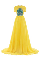 Elegant dragon sun-gown by Le Thanh Hoa, featuring intricate dragon designs and flowing fabric in a traditional gown style.