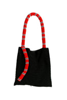 Serpent Big shoulder bag by SAC DE SOUL in black with red and white snake-print design, featuring a structured shape and shoulder strap.