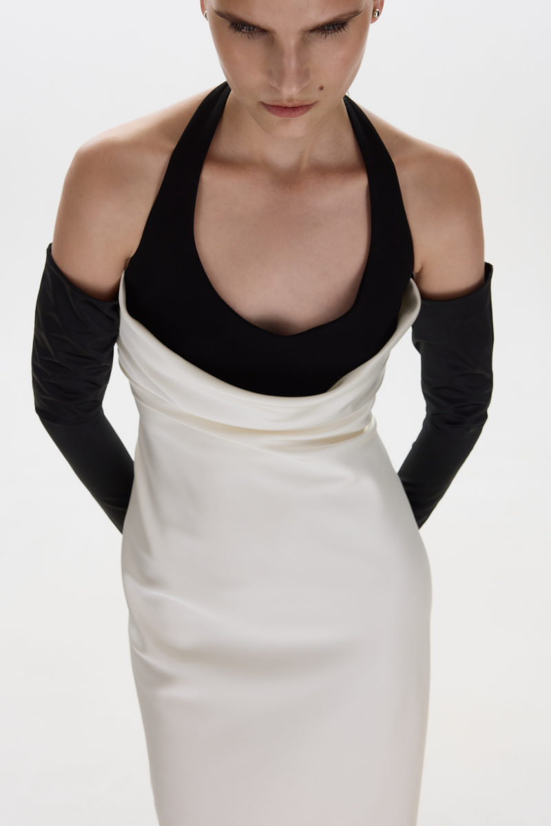 White BALYKINA June midi dress displayed on a hanger, showcasing its elegant length and simple, stylish design.