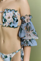 Nur Karaata Misty Mirage bikini with pastel-colored top and matching bottom, displayed on a model against a beach background.