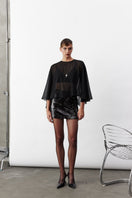 Black chiffon cape jacket by Nazlı Ceren featuring lightweight, flowing fabric and elegant drape, perfect for layered fashion.