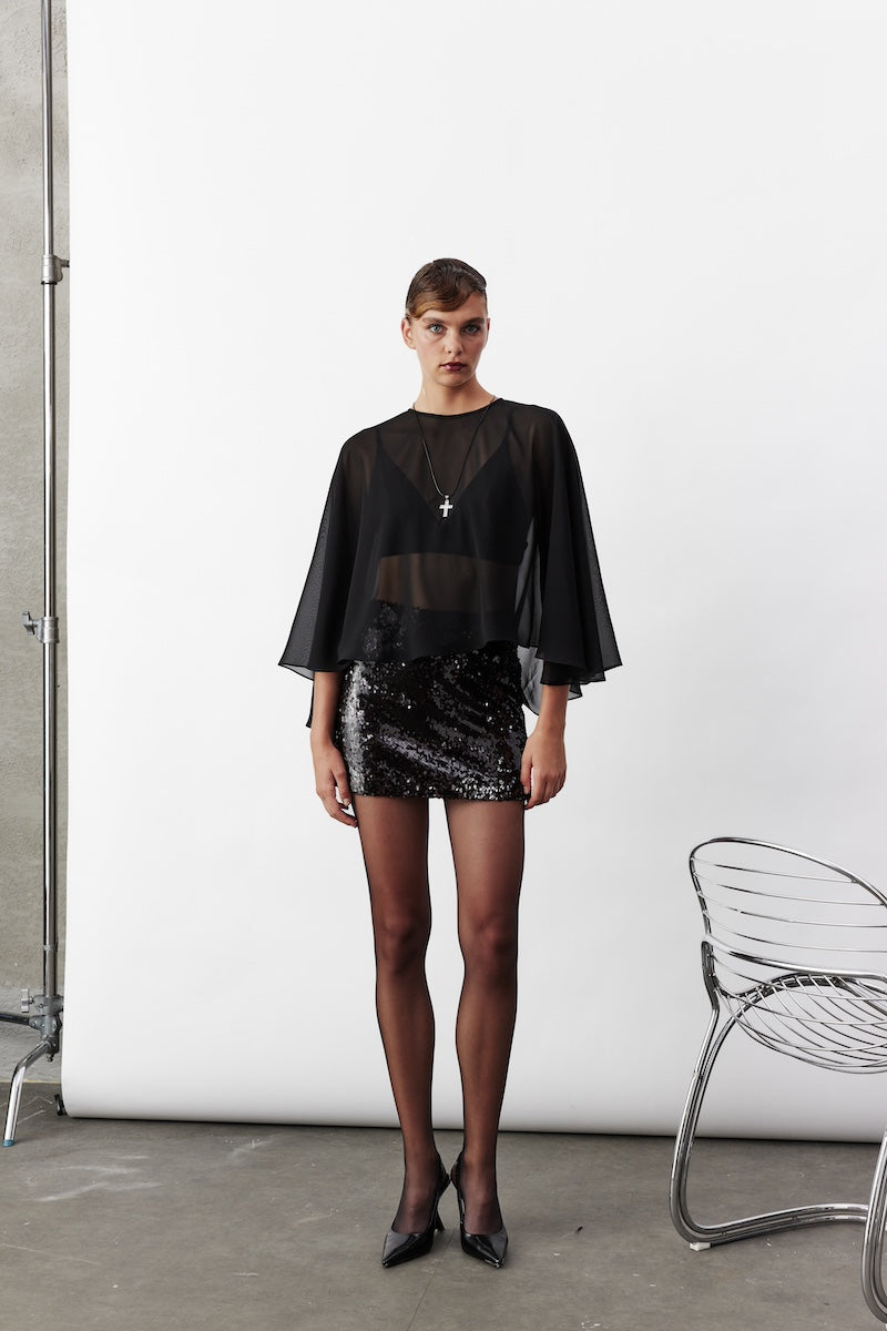 Black chiffon cape jacket by Nazlı Ceren featuring lightweight, flowing fabric and elegant drape, perfect for layered fashion.