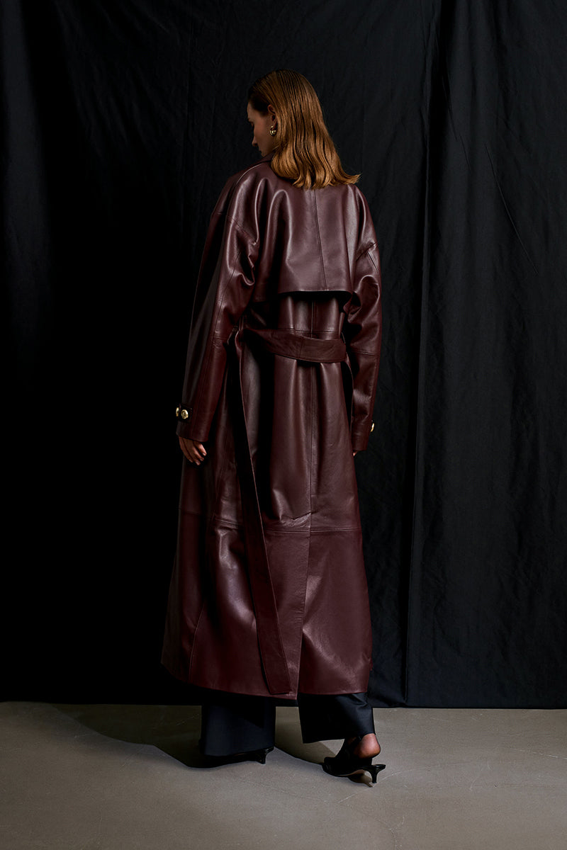 Acaria Studio Journey Leather Trench Coat in cherry red, featuring a sleek silhouette and classic lapel design.