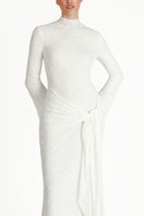 White KELI maxi dress by Khanum's featuring flowing fabric and elegant design displayed on a model.