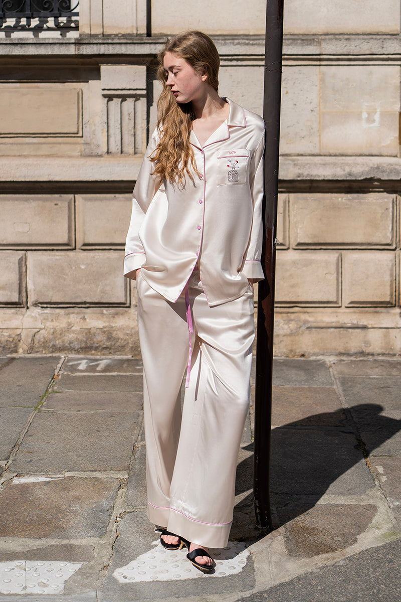 Soft blush pink silk pajamas set by Not Just Pajama featuring long sleeves and relaxed fit for comfortable loungewear.