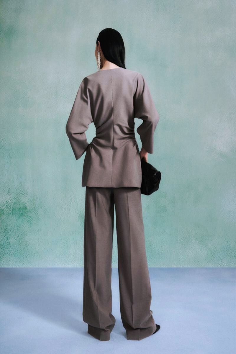 Gray Leicia long sleeve shirt with a fitted silhouette and round neckline, shown on a model.