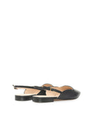 Black Vikele Studio slingback flats sandals with pointed toe and low heel, showcased on a neutral background.
