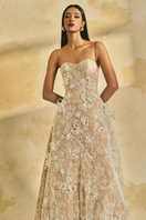 L'SCARLETT A-line spaghetti strap gown with intricate lace and gitter details, elegant and flowing for formal occasions.