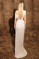 Elegant mushroom crystal long gown by Do Long, flowing fabric with intricate crystal embellishments and a graceful silhouette.