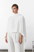White Caro Crepe Cape jacket by Nazlı Ceren, featuring elegant drape and stylish design, displayed on a model.