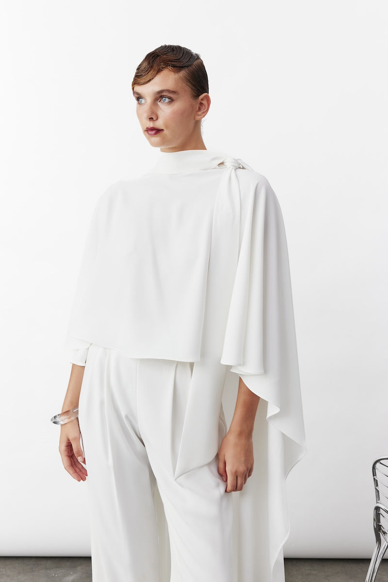 White Caro Crepe Cape jacket by Nazlı Ceren, featuring elegant drape and stylish design, displayed on a model.