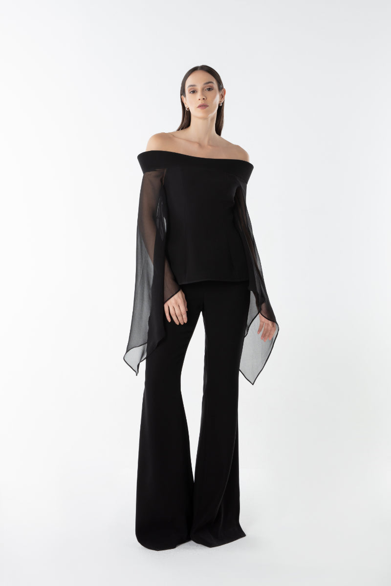 Lili Blanc flow flare trousers featuring wide legs and high waist, made from lightweight fabric, styled for a relaxed look.