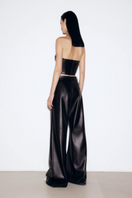 Black faux leather mini corset top by ELENAREVA featuring a fitted design with structured bust and adjustable straps.