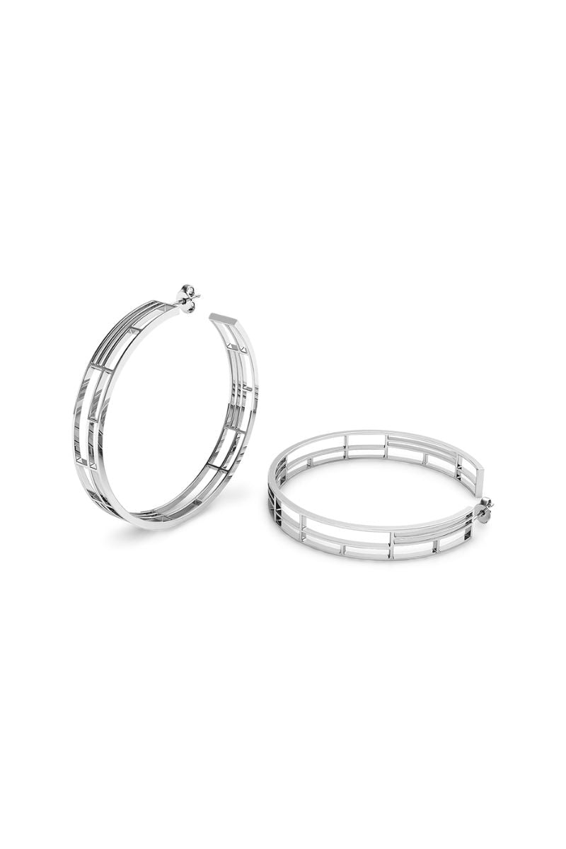 Silver Colosseo hoop earrings by Sara Shala featuring large, shiny hoop design with a sleek silver finish.