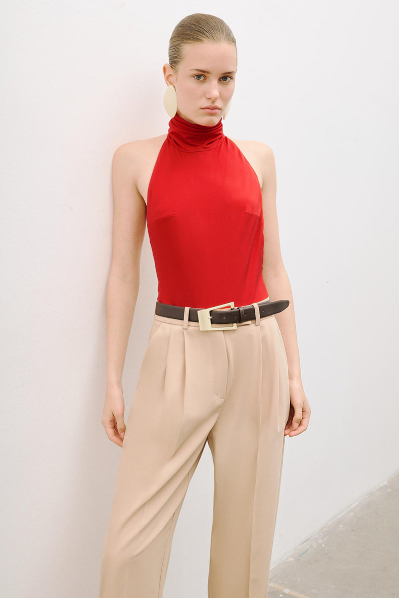 Red AWAVE turtleneck bodysuit with open back detail, form-fitting top, and long sleeves, displayed on a plain background.