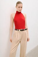 Red AWAVE turtleneck bodysuit with open back detail, form-fitting top, and long sleeves, displayed on a plain background.