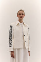 Stylish DELEGAN jacket with decorative ornament, featuring a tailored fit and detailed embellishments for a sophisticated look.
