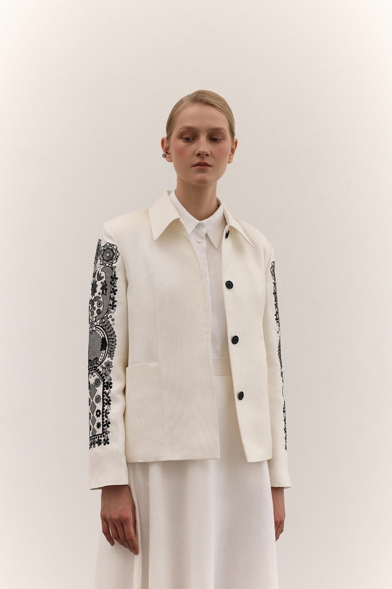Stylish DELEGAN jacket with decorative ornament, featuring a tailored fit and detailed embellishments for a sophisticated look.