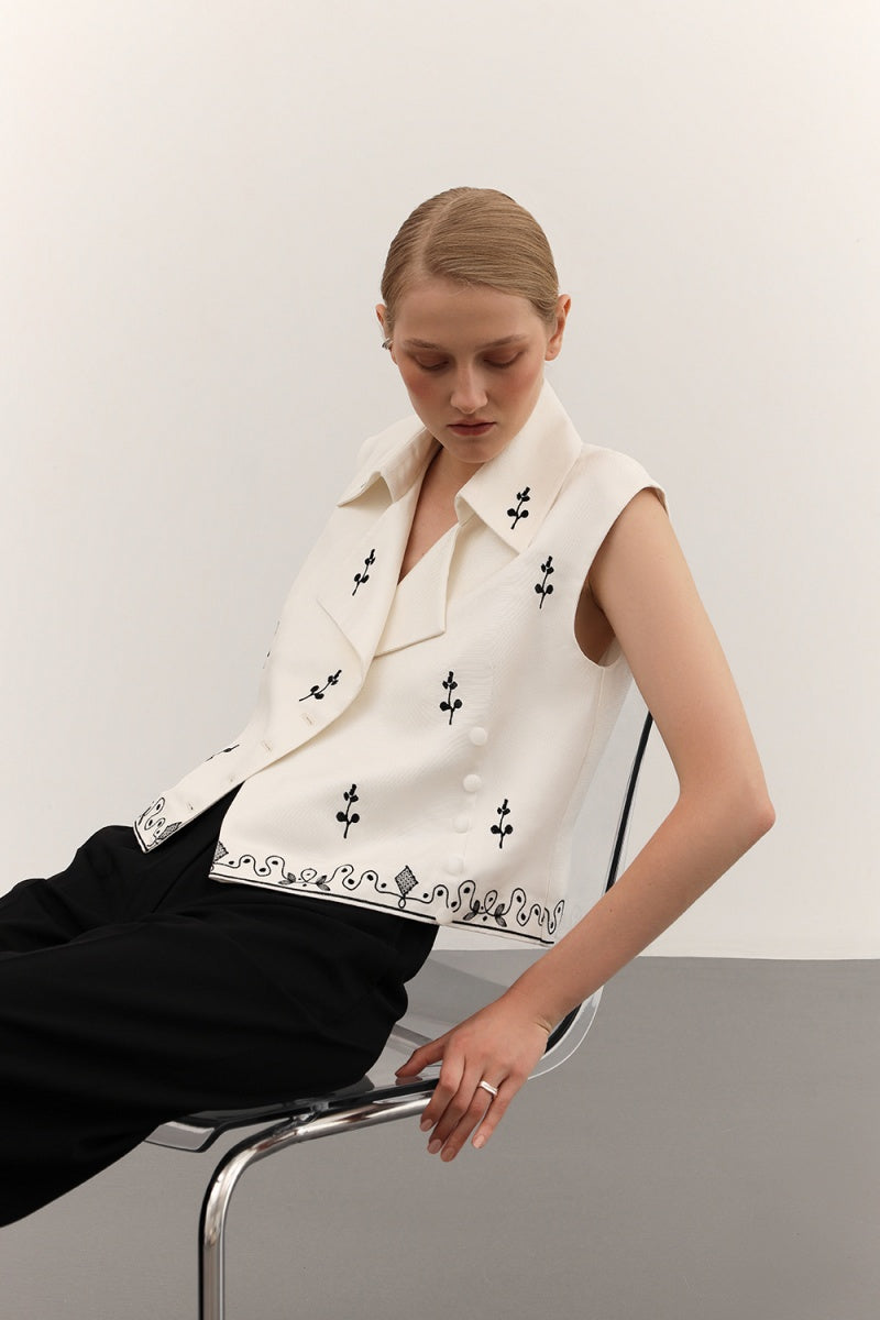 DELEGAN vest with decorative ornament detail, stylish sleeveless garment featuring intricate embellishments and a tailored fit.