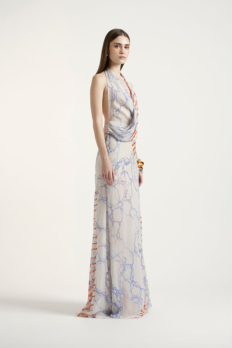 Deme By Gabriella Siena Maxi Dress in flowy fabric with a fitted waist and elegant neckline, displayed on a hanger.