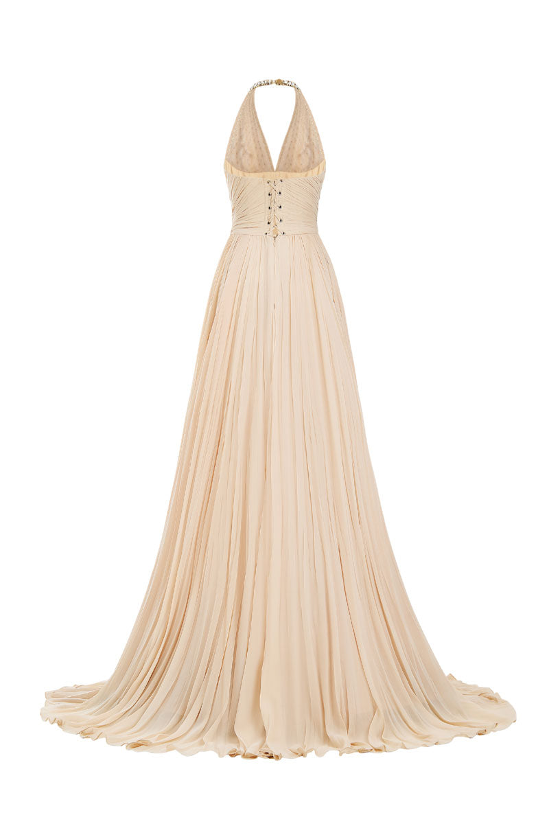 Beige crystal chiffon gown by CEM featuring elegant flowing fabric and intricate crystal embellishments.