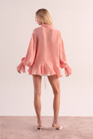 OvertheSea pink splash blouse, a stylish women’s top with vibrant design, shown on a model.