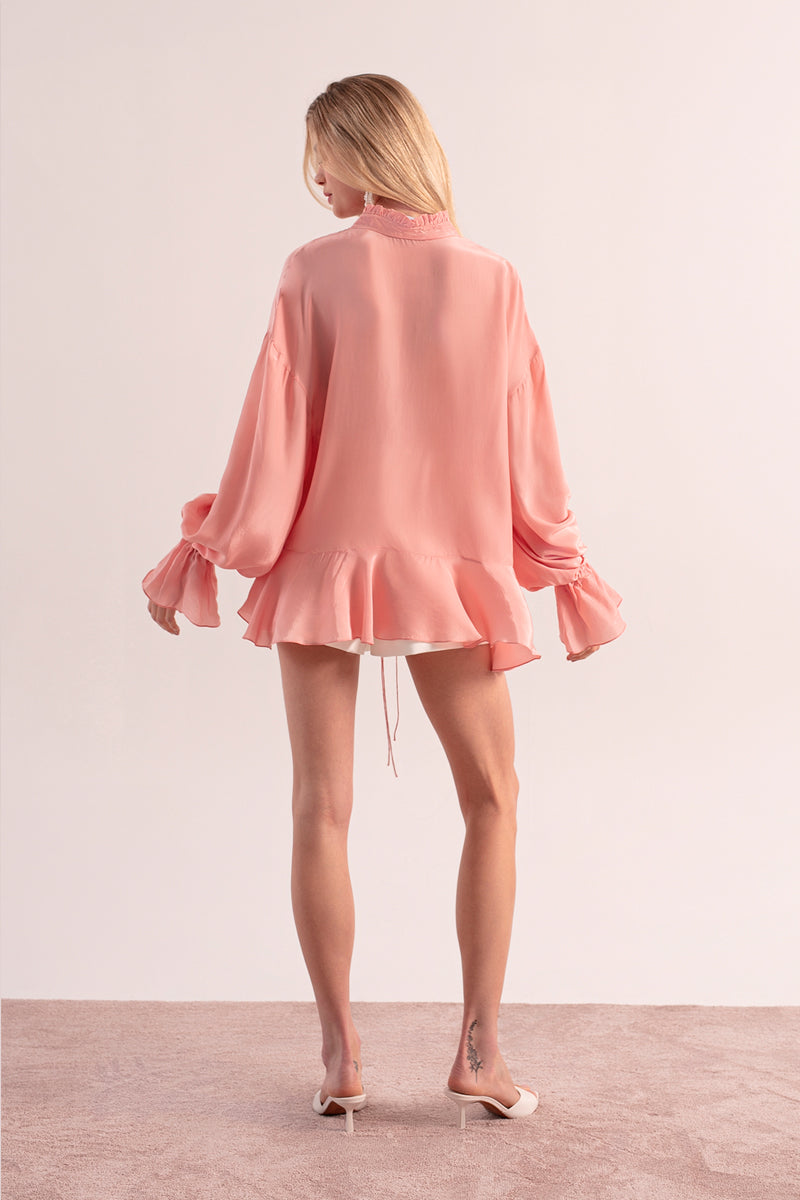 OvertheSea pink splash blouse, a stylish women’s top with vibrant design, shown on a model.