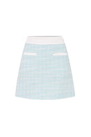 Valenciani mint tweed mini skirt shown with a fitted waist and classic checkered pattern, perfect for stylish casual wear.