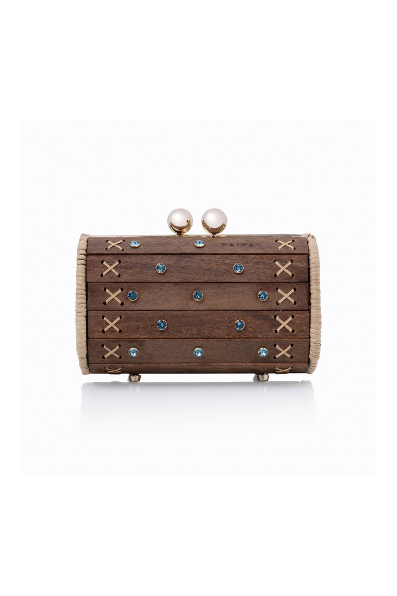 Waiwai Rio Petit Baoba clutch in Oud Safira with a sleek design, featuring a textured blue fabric and elegant gold accents.