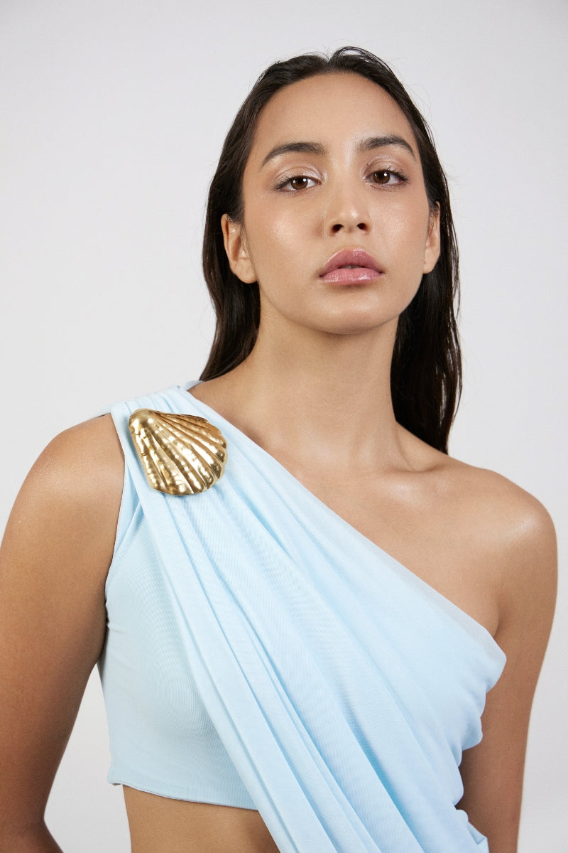 Deme By Gabriella Aurora Blue Maxi Dress featuring flowing fabric, V-neckline, and sleeveless design on a woman model.
