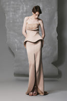 Golden beige peplum trumpet beaded gown by Phan Huy, featuring intricate beadwork and a fitted silhouette with a dramatic peplum detail.