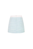 Valenciani mint tweed mini skirt displayed on a model, showing its fitted silhouette and textured fabric.