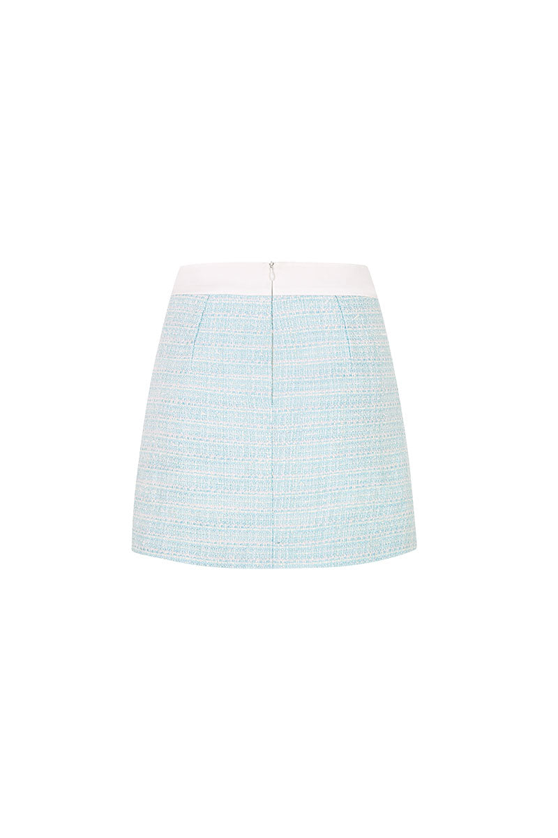 Valenciani mint tweed mini skirt displayed on a model, showing its fitted silhouette and textured fabric.