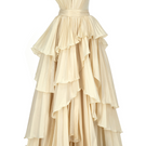 Elegant vanilla tiered gown by Tarık Ediz featuring flowing fabric and a stylish silhouette, perfect for formal occasions.
