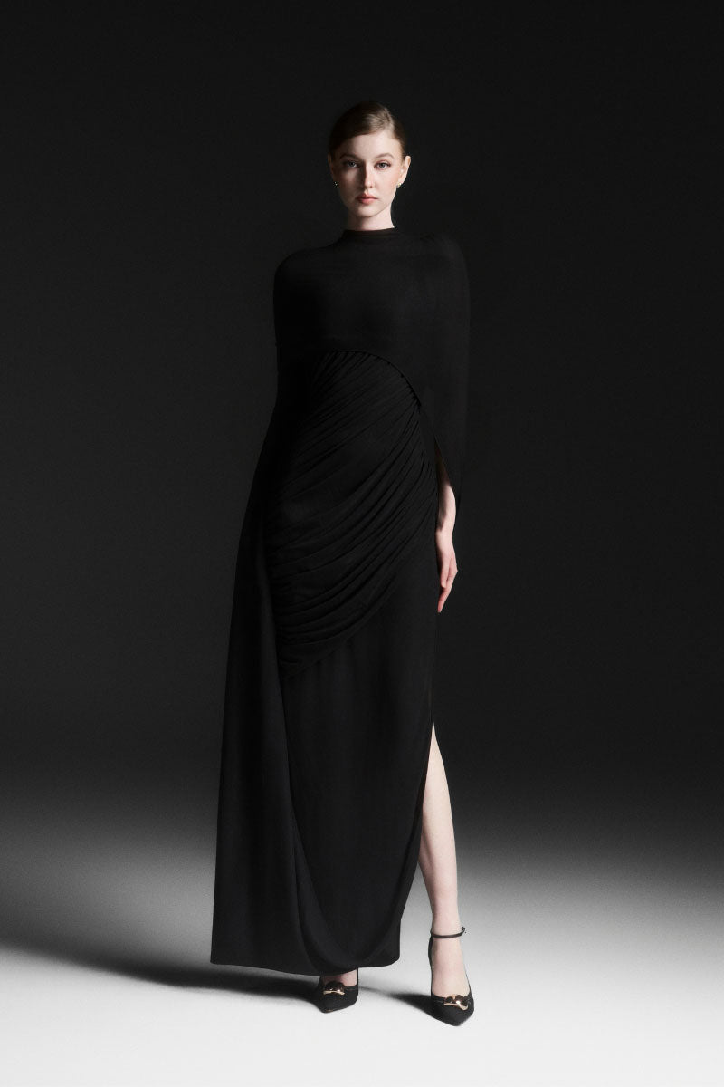 Black Maison Des Copains CELIORA cape-sleeve floor-length maxi dress displayed on a model with flowing fabric and elegant design.