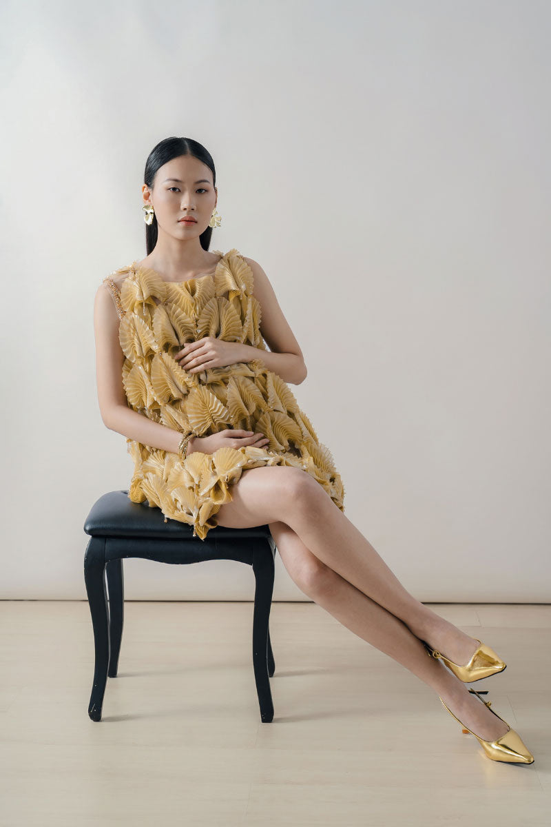 Mustard textured sleeveless mini dress by DOC BAN, featuring a fitted silhouette and stylish sleeveless design.