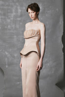 Golden beige peplum trumpet beaded gown by Phan Huy featuring intricate beadwork and a fitted silhouette for elegant occasions.