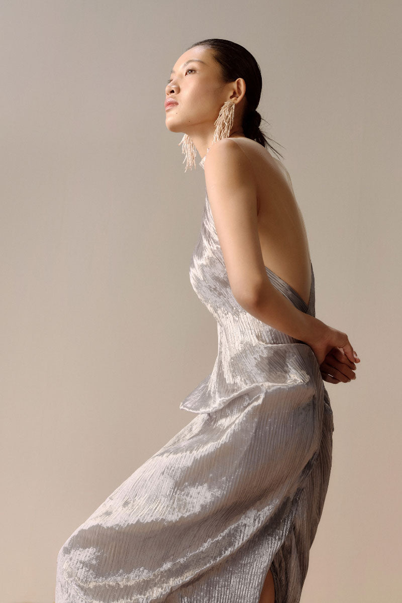 Silver Sand gown in silver, a maxi dress from LECIA featuring a flowing design and elegant fabric, shown on a model.