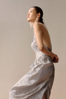 Silver Sand gown in silver, a maxi dress from LECIA featuring a flowing design and elegant fabric, shown on a model.