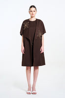 Aidan & Ice NAIRA outer coat in brown, stylish long coat with a tailored fit, displayed on a hanger.