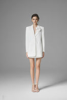 White Ontario mini skirt by Arti Apparel, shown in a stylish close-up image highlighting the fabric and fit.